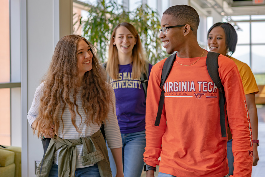 students walking with Virginia Tech and JMU shirts