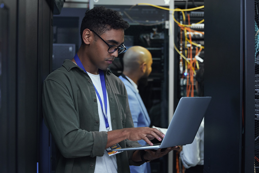 Man with a laptop in a server room