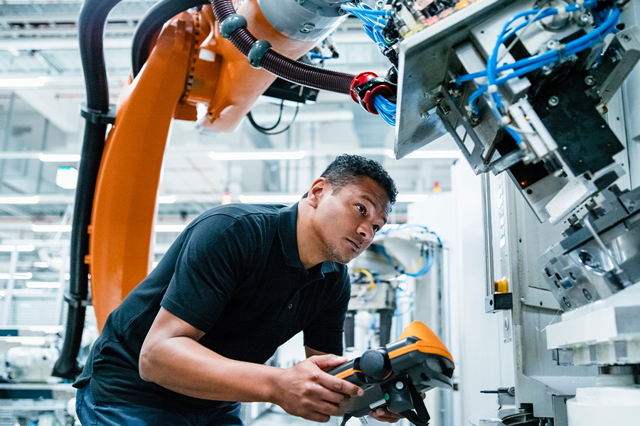 Man working with robotics machinery