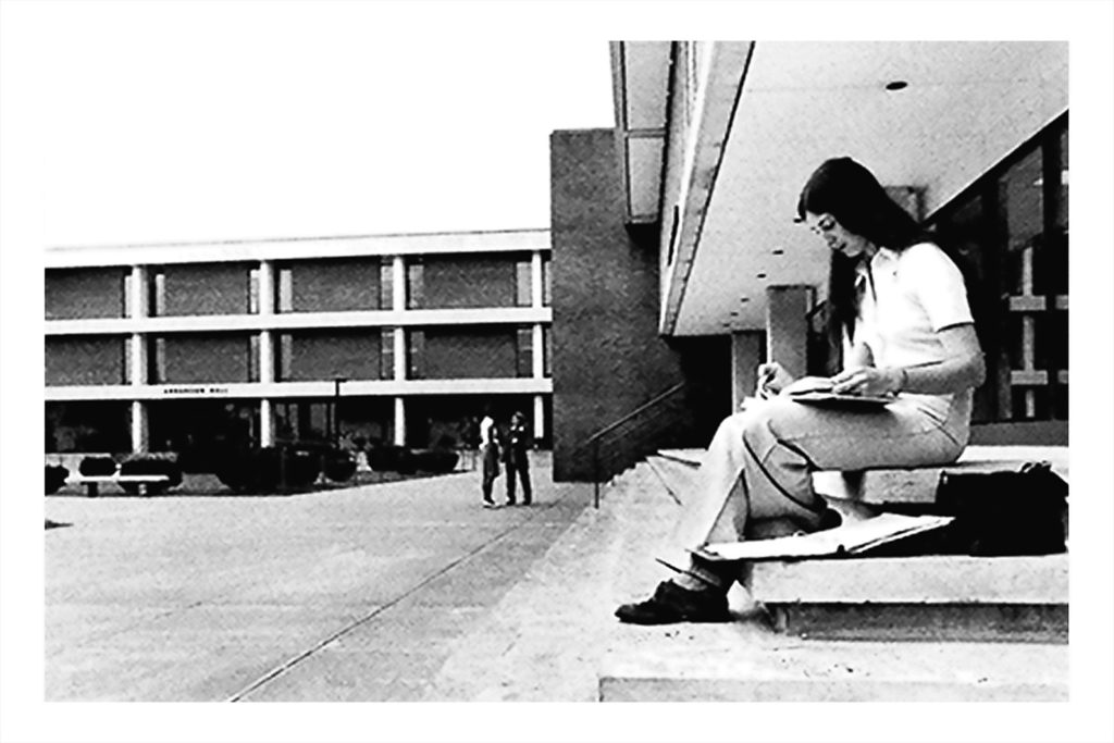 Student studying on the steps in the past