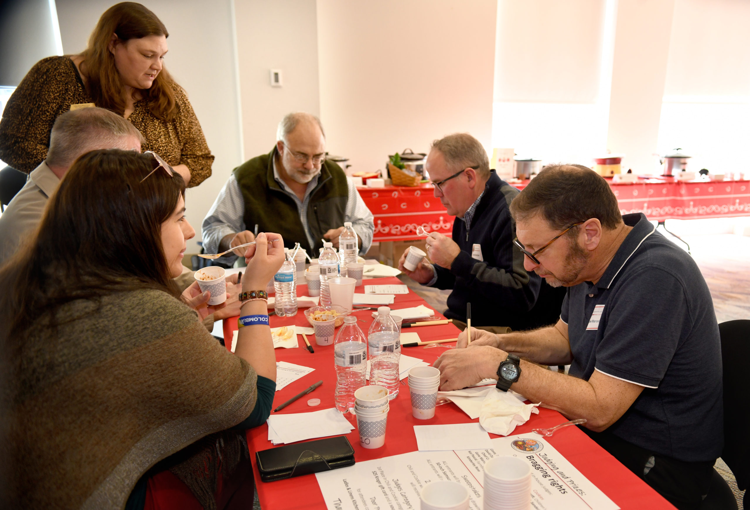 Participants tasting and judging chili