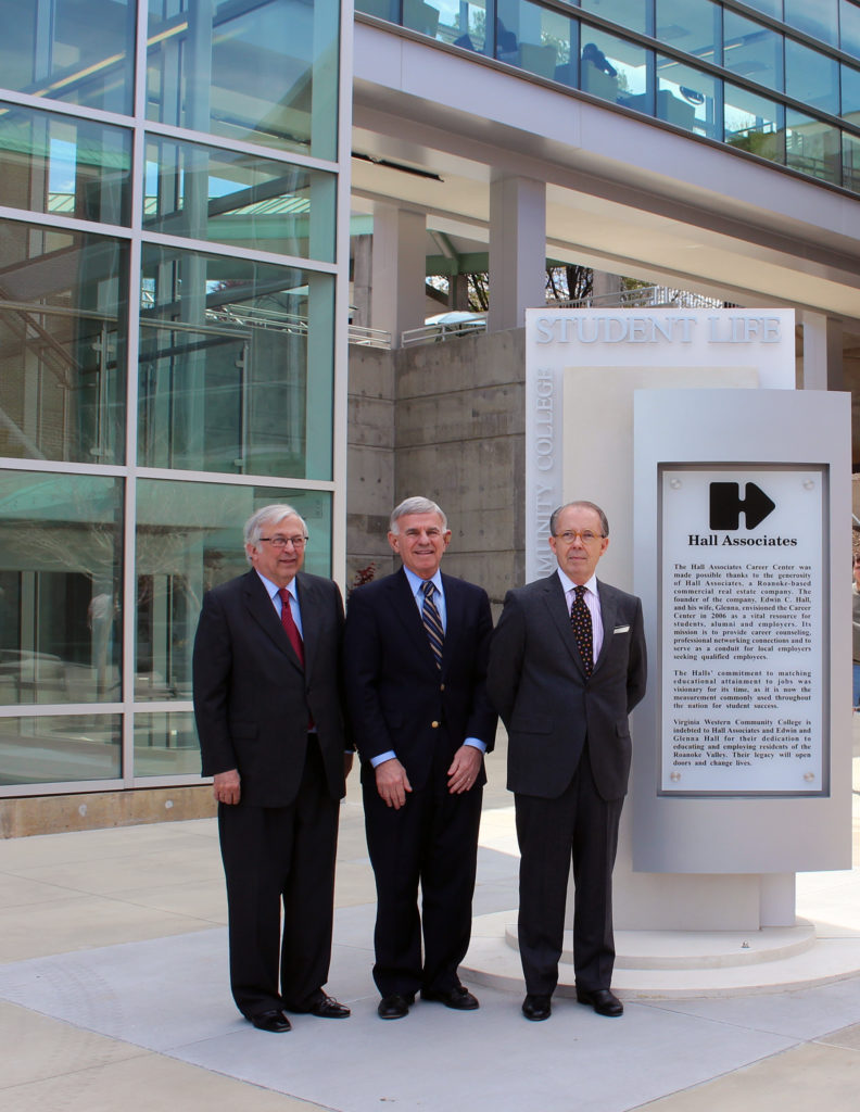 Dr. Charles Steger, Dr. Robert Sandal, and Edwin Hall in front of Hall Associates Career Center sign