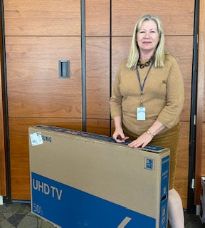 Gayle Clary with sweepstakes prize - a 50 inch TV