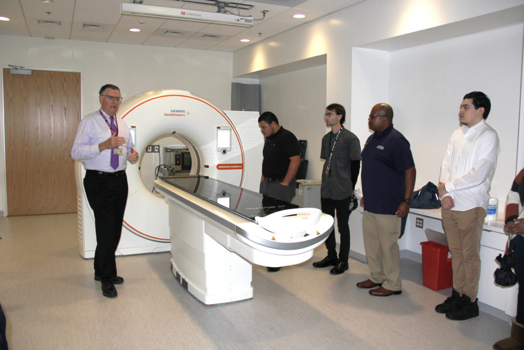 Dr. Michael Friedlander (left), executive director of the Fralin Biomedical Research Institute at VTC, gives a tour to Virginia Western students on Nov. 11, 2022. Students in the CCAP scholarship program learned about FBRI's major research initiatives, such as neuroscience, cancer and heart health. Here, students see a Siemens MRI brain scanner used exclusively for research. CCAP Success Coach Frank Tyree (second from right) was inspired at the October conference to seek tours for Virginia Western students to see the type of research that is being done in Roanoke. Photo courtesy of Virginia Tech.