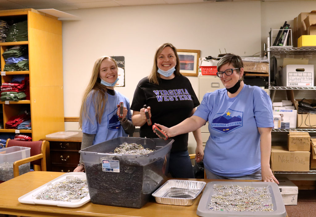 Christine Widener (from left), Kitty Walls and Michele Richardson use magnets to sort donated tabs from cans at the Ronald McDonald House.