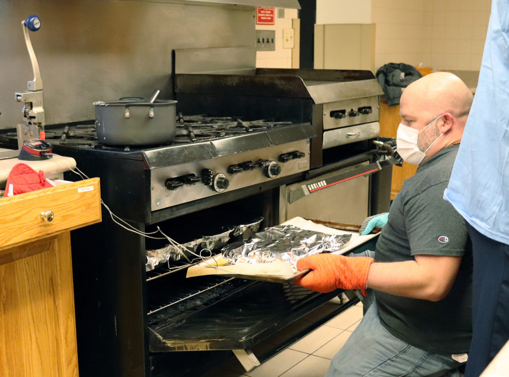 Ray Wickersty helps prepare a meatloaf dinner for the guests at the Ronald McDonald House.