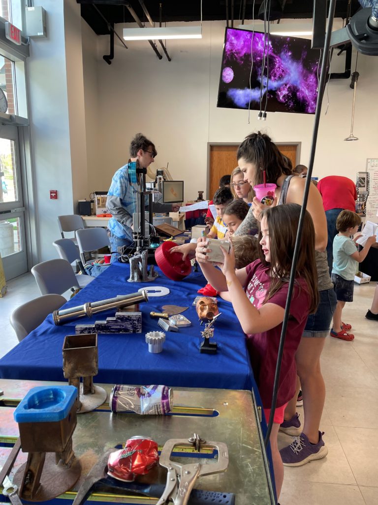 Families tour the Fab Lab on STEM Day.