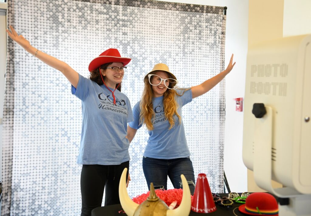 CCAP students Paris Hobbs (left) and Hannah Puskar celebrate Virginia Western's 15th anniversary of the Community College Access Program at the photo booth on Saturday, Sept. 23.