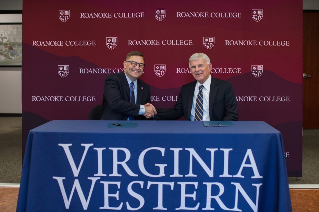 Roanoke College President Frank Shushok Jr. (left) and Virginia Western President Robert Sandel meet to sign an agreement establishing the Rapid Maroons Program on Tuesday, Sept. 5.