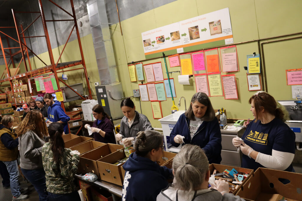 Virginia Western volunteers work together with volunteers from Roanoke College's Center for Civic Engagement at Feeding Southwest Virginia on Jan. 12.