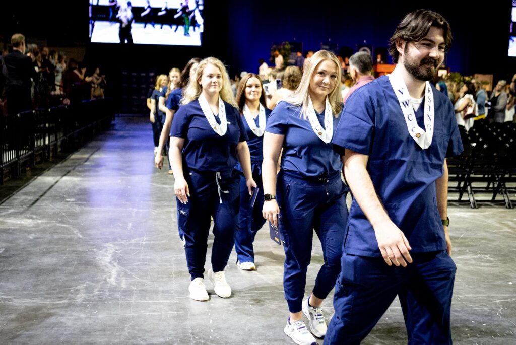 Members of the Class of 2023 file out after being honored at the Nursing Program's Pinning Ceremony on May 12, 2023. Photo courtesy of #amyhaydenphotography.