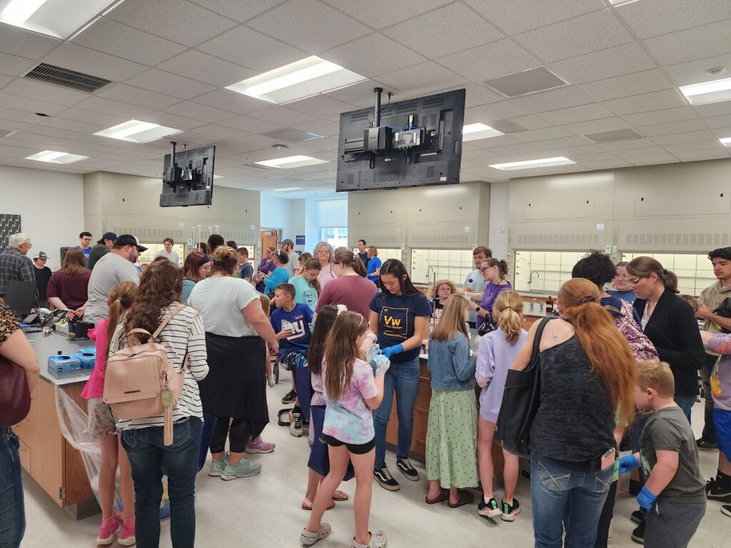 Families enjoy chemistry activities at STEM Day in 2023.