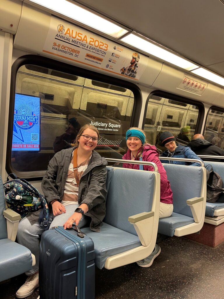 Elizabeth Paige Morris (left) and Hannah Puskar ride the Metro.