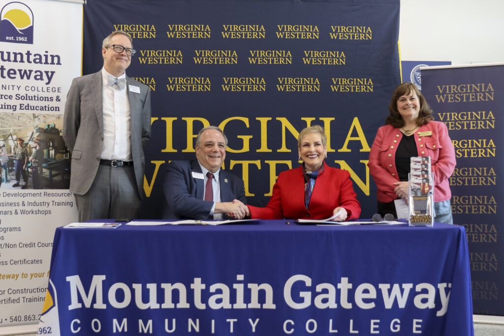 Mountain Gateway Community College and Virginia Western Community College signed an agreement on Tuesday, Feb. 24, to enhance Commercial Driver's License instruction and regional workforce readiness. Pictured are (from left): Dr. Ben Worth, Vice President for Academic Affairs with Mountain Gateway (standing); Dr. John Rainone, President of Mountain Gateway (seated); Dr. Laura J. Treanor, President of Virginia Western (seated); and Dr. Elizabeth Wilmer, Vice President of Academic and Workforce Solutions with Virginia Western. Courtesy of Virginia Western Community College.