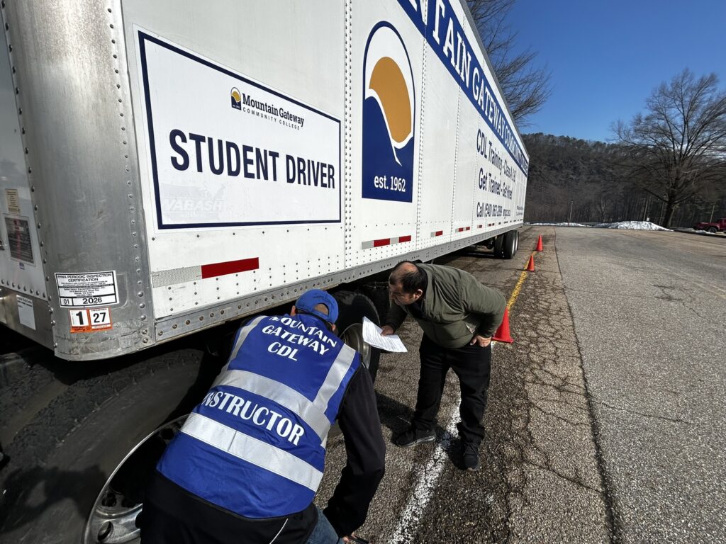 There is currently an acute need for skilled drivers in the Roanoke and Alleghany Highlands regions. Here, a Mountain Gateway Community College instructor demonstrates parts of a training vehicle for Class A CDL tractor-trailer licensure. Courtesy of Mountain Gateway Community College.