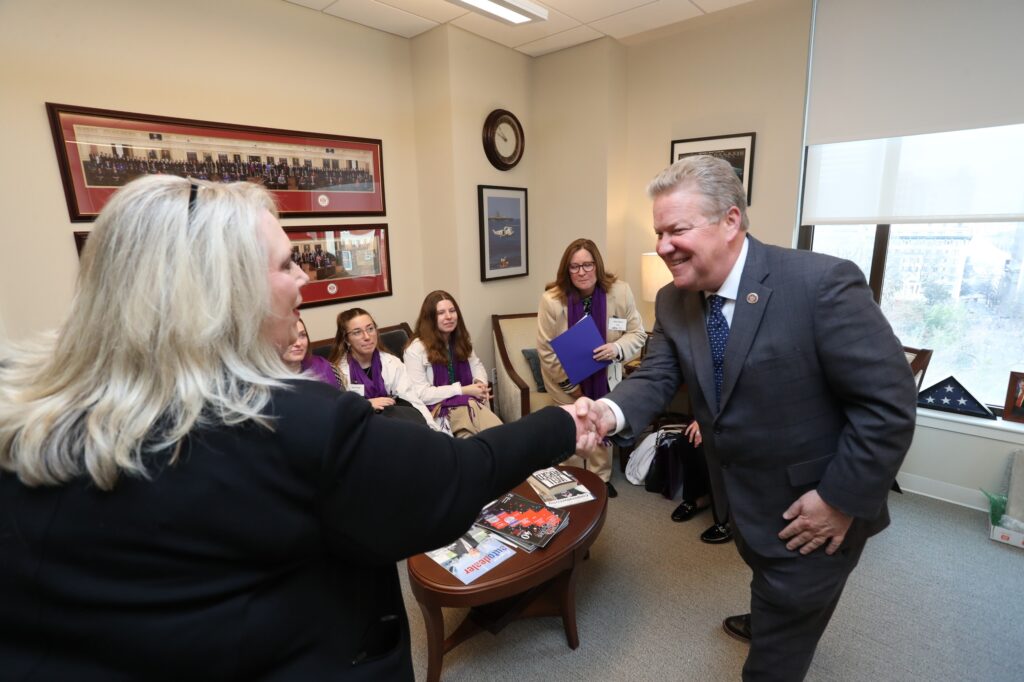 Joanie Bryant (Coordinator for Rally Day and Virginia Western Community College Dental Hygiene Faculty) greets Sen. Bill Stanley.