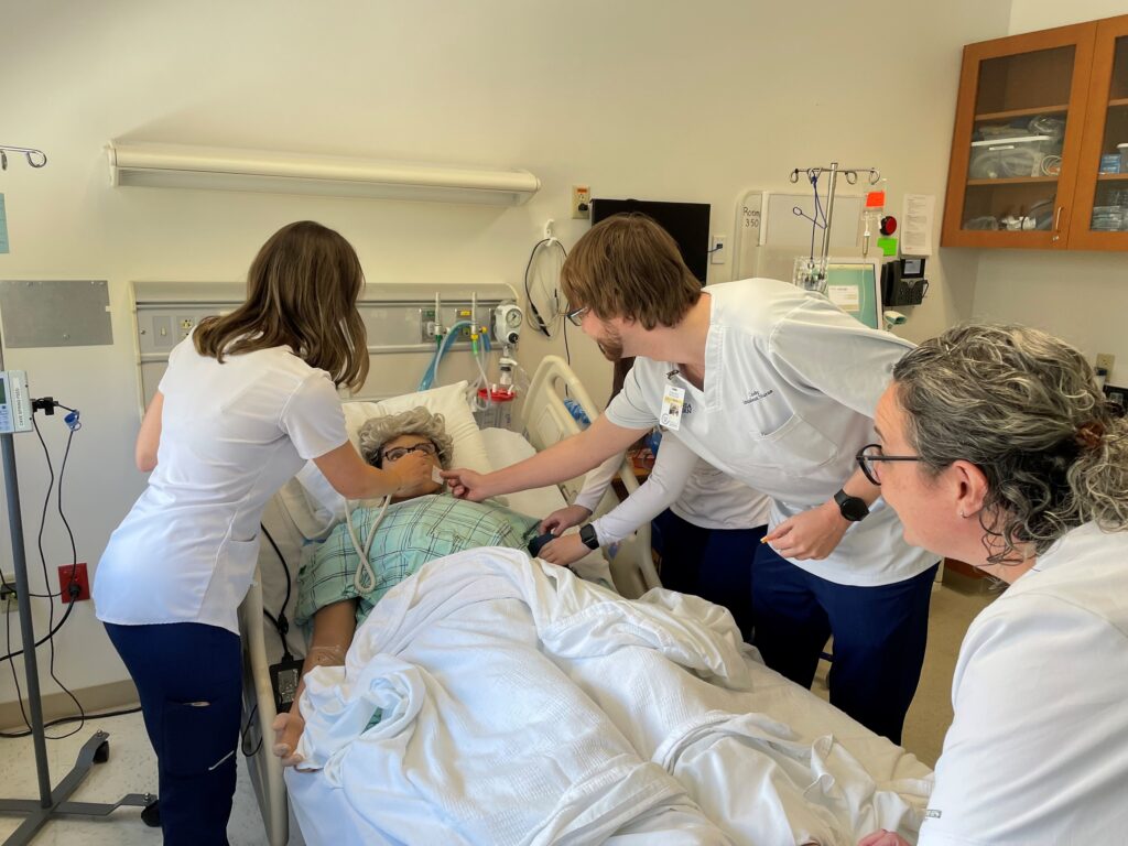 Virginia Western nursing students in the Earn to Learn program practice patient care using a high-fidelity simulation mannequin in a laboratory at Virginia Western.