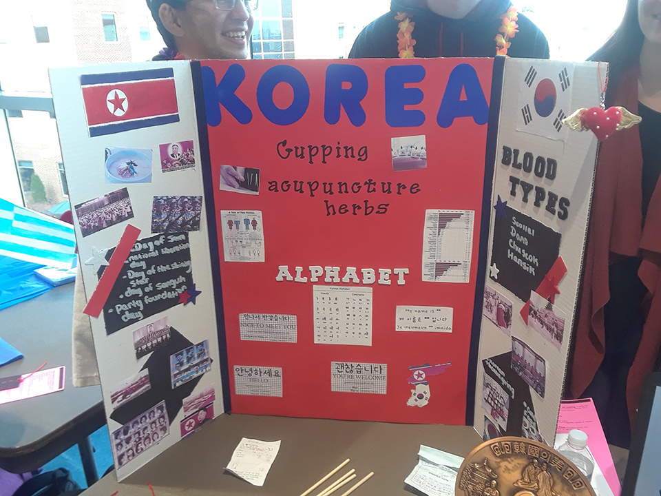 Korean culture is represented at a table at the Nursing Cultural Fair. Students are seen here with information about the Korean culture.