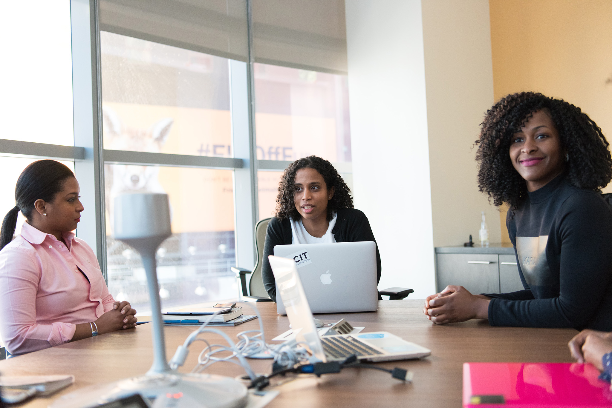 Ladies of Color in a Business Meeting Happy