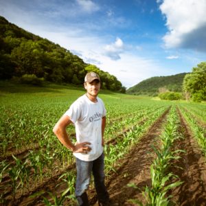 Student standing in corn field