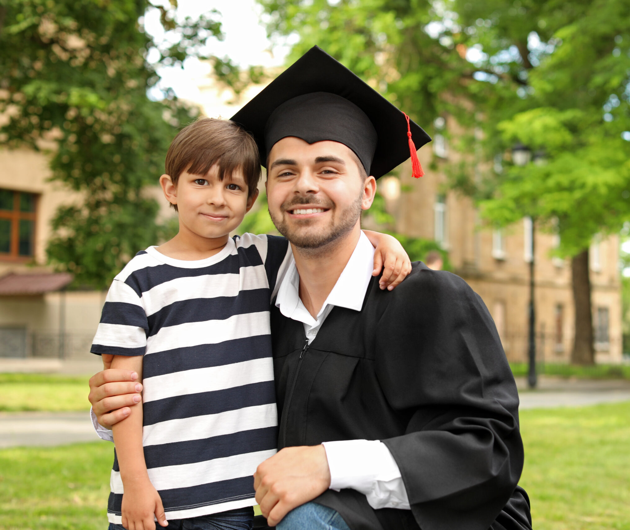 Man with his little son on graduation day